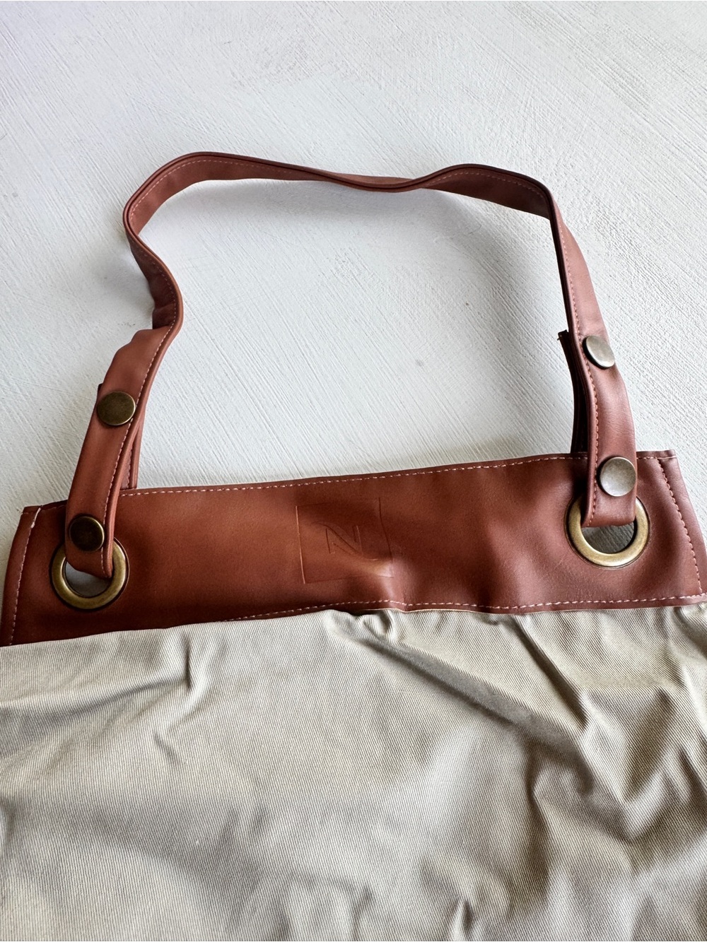 Nespresso apron in neutral beige with Brown Leather Finishes - Picture 2 of 4